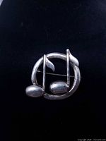 Front view of sterling musical notes brooch