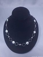 Full view of necklace displayed on black bust form