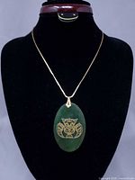 Full view of necklace on display bust showing pendant and chain