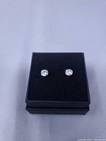 pair of stud earrings in presentation box