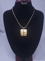 Full necklace displayed on bust showing chain length and pendant