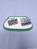 Front view of cuff links in box