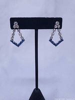 both earrings on stand showing overall design