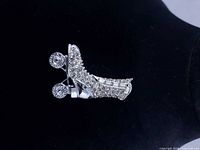 Front view of rhinestone roller skate brooch