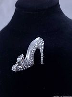 Full view of rhinestone stiletto brooch on display stand