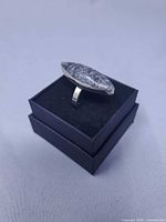 Ring on presentation box, side view showing stone length and band