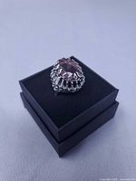 ring angled view showing stone colour and basket setting