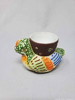 Front angled view showing bird shape, cup and glazing