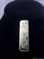 front view of rectangular pin showing two-tone Celtic design