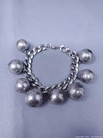 Full view of bracelet showing chain and eight ball charms
