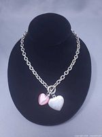 Full view of choker on display bust showing chain and heart pendants