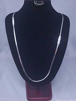 Full view of necklace draped on display bust showing length and overall design