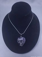 Full view of necklace on bust displaying chain length and pendant size