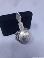 Front view showing floral engraving and applicator inserted