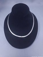 Full view of sterling silver herringbone necklace on display bust