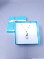 Pendant and chain displayed in blue gift box