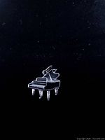 Front view of sterling silver piano charm