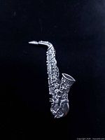 front view of sterling silver saxophone brooch