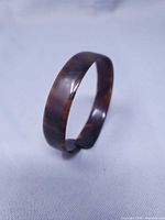 Full view of tortoiseshell-pattern bangle standing upright