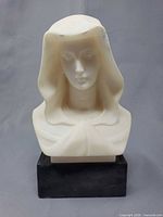 Front view of alabaster Virgin Mary bust on dark base