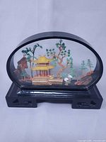 Front view showing entire oval diorama with stand