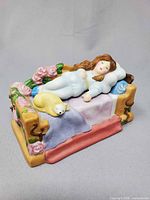 Assembled figurine showing Sleeping Beauty on bed