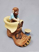 Elf on spool placed beside boot, showing scale and detailing