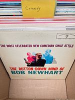 Front of box showing multiple comedy LPs, top album Bob Newhart