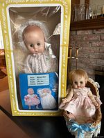Boxed Effanbee doll, small doll seated in cradle