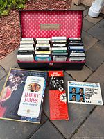 All items: carrying case open with 8-track tapes plus three boxed sets arranged in front