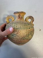 Full front view of ceramic vase showing glaze, handles, body decoration