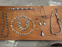 All eight Brighton jewelry pieces laid on board