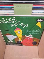 Cover of "College Medleys" vinyl album in box with other records