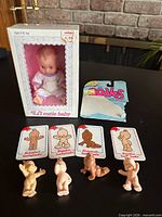 Boxed Li'l Cutie Baby doll, four figurines, four cards, blister card fragment