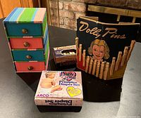 All items grouped: fabric chest, Dolly Pins package, Primpies Diaper Set box and small accessory box