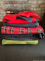 Stack of five folded fabrics showing colors and patterns