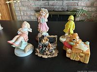 All five figurines grouped on tabletop