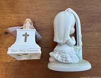 Two First Holy Communion figurines on wooden surface