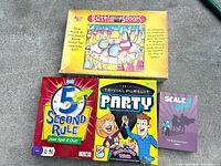 Top view of four boxed games: Battle of the Sexes, 5 Second Rule Just Spit It Out, Trivial Pursuit Party, Scale Up!