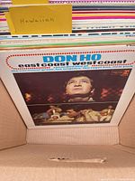 Front view of record lot showing Don Ho East Coast / West Coast album at front of stack in box