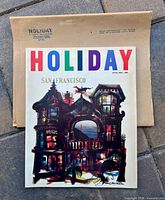 Front cover of Holiday magazine with mailing sleeve behind