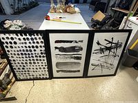 All three framed prints standing together showing designs