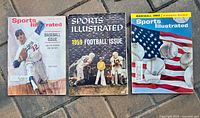 Three Sports Illustrated magazine covers, Baseball issue with player, 1959 Football issue, Baseball 1966 issue with flag and baseballs