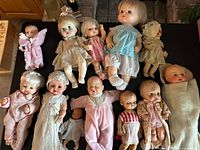 Group shot of all 12 dolls arranged on table