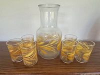 Pitcher and six glasses displayed