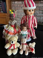 Group shot of three dolls and three teddy bears