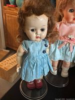Brunette doll with blue gingham dress, red shoes
