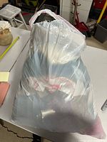 Plastic bag containing assorted women’s clothing