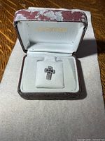 Cross pin inside presentation box
