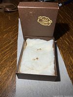 closed presentation box containing pair of pearl stud earrings